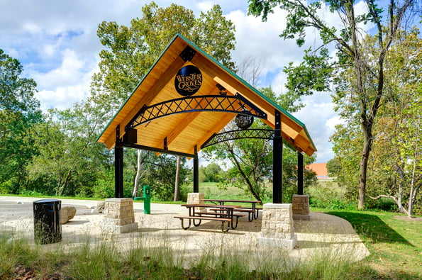 Ironworks square shelter along a greenway with trees surrounding the shelter